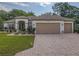 Charming single-story home with a three-car garage and well-manicured front lawn at 9509 Se 124Th Loop, Summerfield, FL 34491