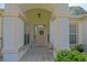 Inviting front entrance with tiled walkway leading to front door, decorative wreath, and ample light at 9509 Se 124Th Loop, Summerfield, FL 34491
