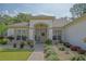 Charming single-story home featuring manicured landscaping and brick walkway leading to the front door at 9509 Se 124Th Loop, Summerfield, FL 34491