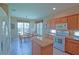 Bright eat-in kitchen featuring an island, tile floors, stainless appliances and a breakfast nook with lots of light at 9509 Se 124Th Loop, Summerfield, FL 34491