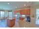 Bright, fully-equipped kitchen with granite countertops, modern appliances, and a breakfast bar at 9509 Se 124Th Loop, Summerfield, FL 34491