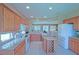 Open kitchen featuring an island with wine rack, white appliances, granite countertops and plenty of natural light at 9509 Se 124Th Loop, Summerfield, FL 34491