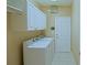 Bright laundry room includes modern appliances and plenty of storage at 9509 Se 124Th Loop, Summerfield, FL 34491