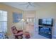 Comfortable living room with plush seating, adjacent to a dining area, with a ceiling fan at 9509 Se 124Th Loop, Summerfield, FL 34491