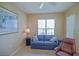 Comfortable seating area with a ceiling fan and a window providing natural light at 9509 Se 124Th Loop, Summerfield, FL 34491
