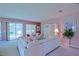 Bright living room with plush seating, decorative furnishings and a view to the outdoor living space at 9509 Se 124Th Loop, Summerfield, FL 34491