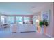 Bright living room with plush seating, decorative furnishings and a view to the dining room and pool at 9509 Se 124Th Loop, Summerfield, FL 34491
