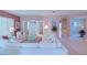 Open living room with plush white seating, decorative furnishings and a view to the entry foyer at 9509 Se 124Th Loop, Summerfield, FL 34491