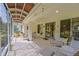 Spacious screened patio with multiple seating areas perfect for entertaining or relaxing outdoors at 9509 Se 124Th Loop, Summerfield, FL 34491