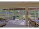 Large screened patio features outdoor seating and view of the landscaped backyard and playground at 9509 Se 124Th Loop, Summerfield, FL 34491