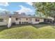 Well-maintained backyard offers a serene outdoor space with green grass and a screened lanai at 9820 Sw 89Th Ter # B, Ocala, FL 34481