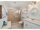 Clean bathroom with a glass-enclosed shower, white vanity, and updated fixtures at 9820 Sw 89Th Ter # B, Ocala, FL 34481