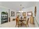 Cozy dining area features a glass table, charming rattan chairs, and stylish décor at 9820 Sw 89Th Ter # B, Ocala, FL 34481