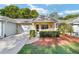 Charming single story home boasts a manicured lawn, attached garage, and covered entryway with space to sit at 9820 Sw 89Th Ter # B, Ocala, FL 34481