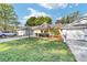 Charming single story home boasts a manicured lawn, attached garage, and covered entryway with space to sit at 9820 Sw 89Th Ter # B, Ocala, FL 34481