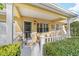 Cozy front porch with decorative details, seating, and a manicured hedge for added privacy, perfect for relaxation at 9820 Sw 89Th Ter # B, Ocala, FL 34481