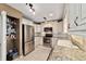Updated kitchen boasting stainless steel appliances, granite counters, and white cabinetry at 9820 Sw 89Th Ter # B, Ocala, FL 34481