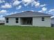 Exterior view of home showing covered lanai and lush green backyard at 2166 Nw 23Rd Loop, Ocala, FL 34475