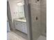Modern bathroom featuring a tiled shower, granite countertop vanity, and tile flooring at 2166 Nw 23Rd Loop, Ocala, FL 34475