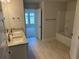 Bathroom featuring granite counters, white cabinets, and a shower/tub combo at 2166 Nw 23Rd Loop, Ocala, FL 34475