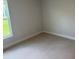Cozy bedroom featuring neutral carpeting and bright natural light at 2166 Nw 23Rd Loop, Ocala, FL 34475