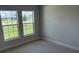 Bright bedroom featuring neutral carpet, a fresh coat of paint, and bright windows at 2166 Nw 23Rd Loop, Ocala, FL 34475