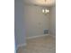 Dining room showcasing a modern chandelier, light gray walls and wood-look tile flooring at 2166 Nw 23Rd Loop, Ocala, FL 34475
