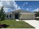 Charming single-story home with a two-car garage and well-manicured front lawn at 2166 Nw 23Rd Loop, Ocala, FL 34475