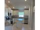 Modern kitchen with white cabinets, stainless steel appliances, and a granite countertop island at 2166 Nw 23Rd Loop, Ocala, FL 34475