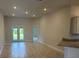Bright living room with tile flooring, recessed lighting, and access to the backyard at 2166 Nw 23Rd Loop, Ocala, FL 34475