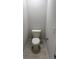 A small bathroom with a toilet, light gray walls, and light gray tile flooring at 2166 Nw 23Rd Loop, Ocala, FL 34475