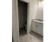 Bathroom features granite countertop, white cabinets, tile flooring, and private toilet area at 2218 Nw 23Rd Loop, Ocala, FL 34475