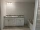 Bathroom featuring a double vanity, granite countertop and a soaking tub, designed for comfort and style at 2218 Nw 23Rd Loop, Ocala, FL 34475