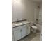 Bathroom featuring a granite countertop, a single vanity, and a bathtub, offering a clean and functional space at 2218 Nw 23Rd Loop, Ocala, FL 34475