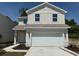 Charming two-story home featuring a two-car garage, tidy landscaping, and a modern architectural design at 2218 Nw 23Rd Loop, Ocala, FL 34475