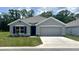 Charming single-story home with a well-manicured lawn and attached two-car garage at 2905 Ne 21St Terrace Rd, Ocala, FL 34470