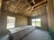 Partially framed interior with insulation, concrete floors, and natural light from windows at 4522 Sw 90Th Lane Rd, Ocala, FL 34476