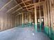 Spacious home interior with exposed framing, insulation, concrete floors, and natural light at 4522 Sw 90Th Lane Rd, Ocala, FL 34476