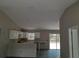 Open concept living area with lots of light, vaulted ceiling, and modern kitchen at 5810 Se 170Th Ct, Ocklawaha, FL 32179