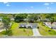 Aerial view showcases a well-maintained home with a lush green lawn, mature trees, and neighborhood charm at 10190 Se 178Th St, Summerfield, FL 34491