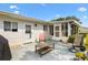 Back patio with cozy seating. View of the screen room and the green, fenced backyard at 10190 Se 178Th St, Summerfield, FL 34491
