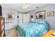 Cozy bedroom features light blue walls, a ceiling fan, ample closet space, and bright natural light at 10190 Se 178Th St, Summerfield, FL 34491