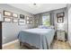This bedroom showcases a gray-toned wall, complemented by a plush bed and an array of framed decor at 10190 Se 178Th St, Summerfield, FL 34491