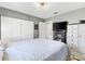 Comfortable bedroom with a ceiling fan, plenty of storage, and a modern TV with stand at 10190 Se 178Th St, Summerfield, FL 34491