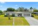 Charming single-story home featuring well-maintained landscaping, a screened garage, and a welcoming front porch at 10190 Se 178Th St, Summerfield, FL 34491