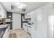 Well-lit kitchen featuring white appliances, ample cabinetry, and modern countertops with a skylight at 10190 Se 178Th St, Summerfield, FL 34491