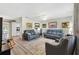 Cozy living room showcasing modern furnishings, neutral decor, and a seamless flow to the kitchen at 10190 Se 178Th St, Summerfield, FL 34491
