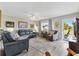 Bright living room featuring hardwood floors, comfortable seating, and plenty of natural light at 10190 Se 178Th St, Summerfield, FL 34491