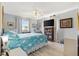 Inviting main bedroom with large windows, a ceiling fan, and comfortable furnishings and décor at 10190 Se 178Th St, Summerfield, FL 34491