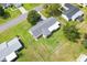 Aerial view of house showing well-manicured lawn and white vinyl fencing at 10385 Se 178Th St, Summerfield, FL 34491
